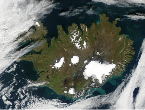 Satellite imagery of Iceland, stark white in a dark blue sea in the subarctic region just east of Greenland