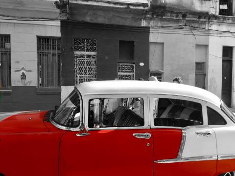 Red taxi parked in a Central Havana Street