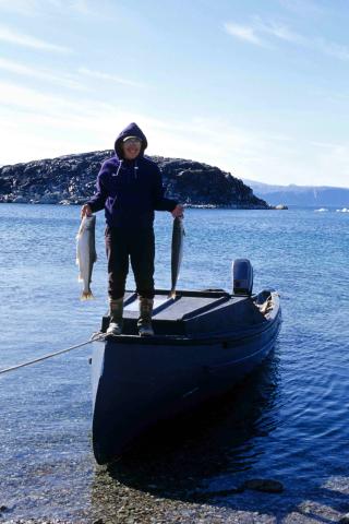 Fisherman holding sea run char 